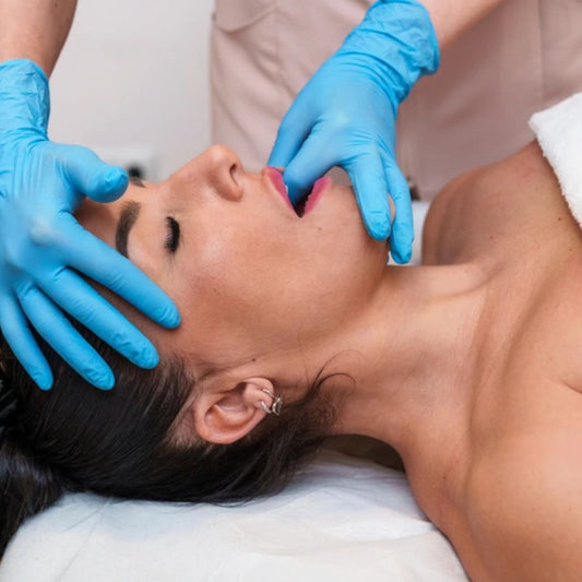 Woman receiving TMJ treatment while sleeping at Invisalign Center.